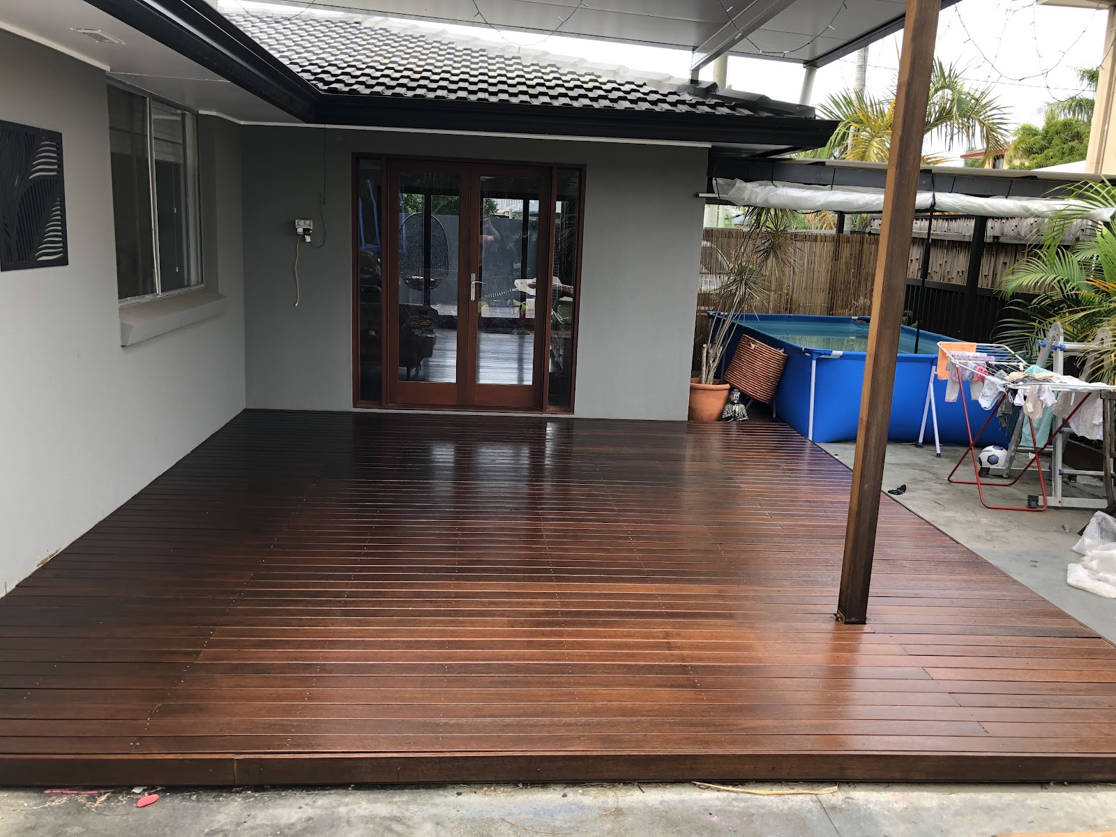 Freshly stained dark timber deck at the back of a house