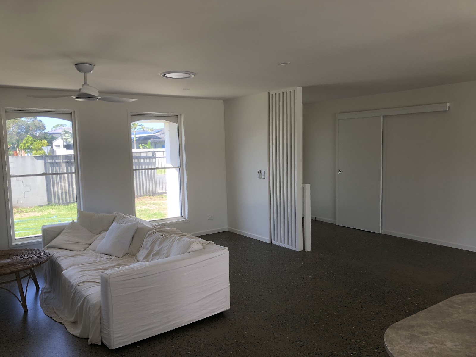 White living room with a timber batten feature wall